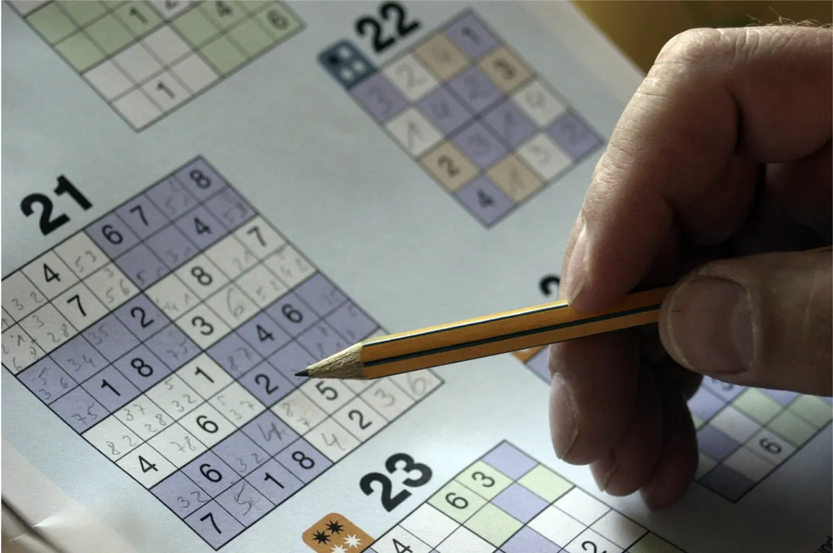 Hand solving a sudoku puzzle with a pencil